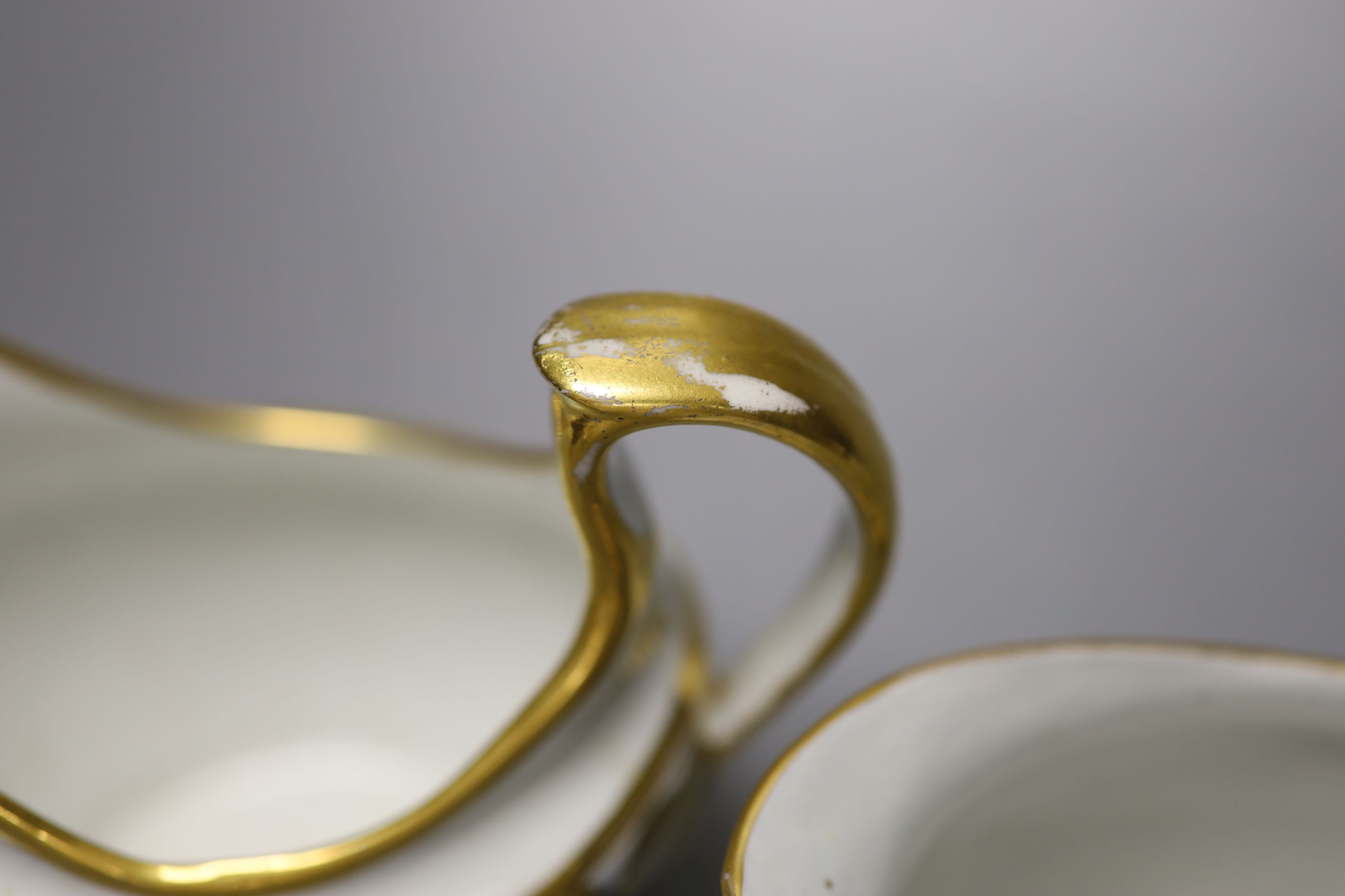 A Coalport hybrid hard paste cream jug in blue and gilt, a Miles Mason blue and gilt cream jug, impressed M. Mason, and a Ridgway cream